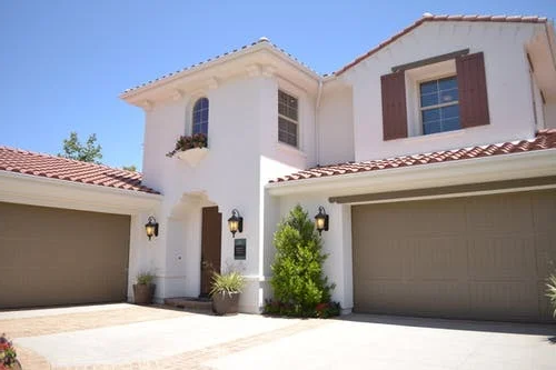 Garage doors flanking home entrance